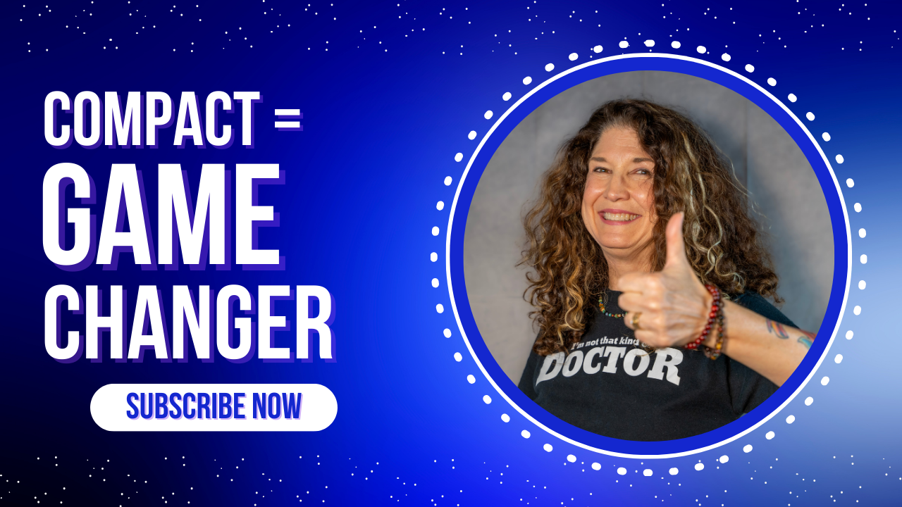 A smiling woman with long curly hair gives a thumbs up. She is wearing a black T-shirt that says “I’m not that kind of DOCTOR.” The background is a bright blue gradient with white dotted accents resembling stars. To the left, bold white and purple text reads: “COMPACT = GAME CHANGER.” Below that is a white button with blue text: “SUBSCRIBE NOW.” The image promotes the Counseling Compact as a transformative development for therapists.